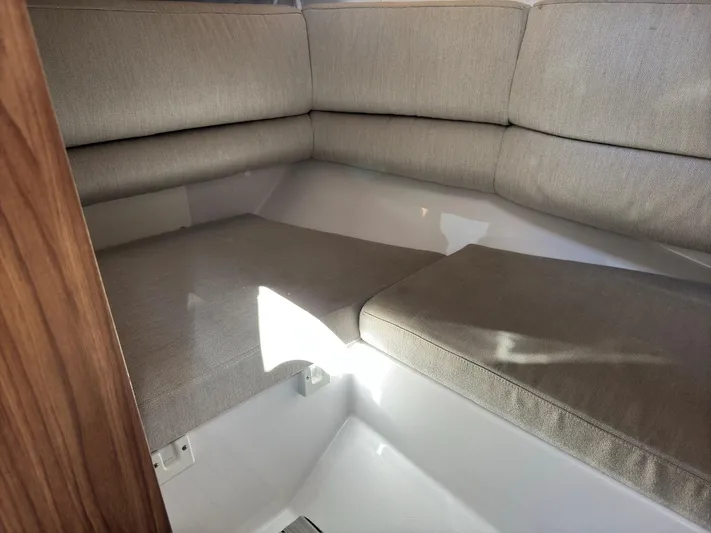 The Good Life Yacht Photos Pics 2019 Four Winns H350 interior with beige cushioned seating in a cozy corner layout.