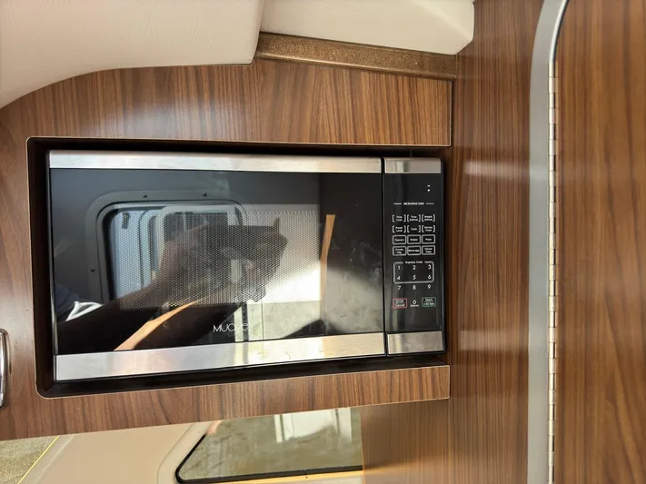 The Good Life Yacht Photos Pics Microwave in 2019 Four Winns H350 boat interior with wood paneling.