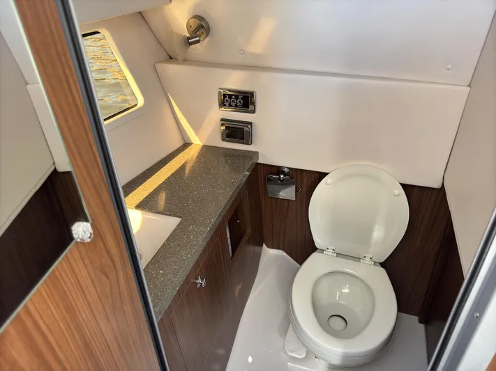 The Good Life Yacht Photos Pics 2019 Four Winns H350 boat bathroom with modern fixtures and wood accents.
