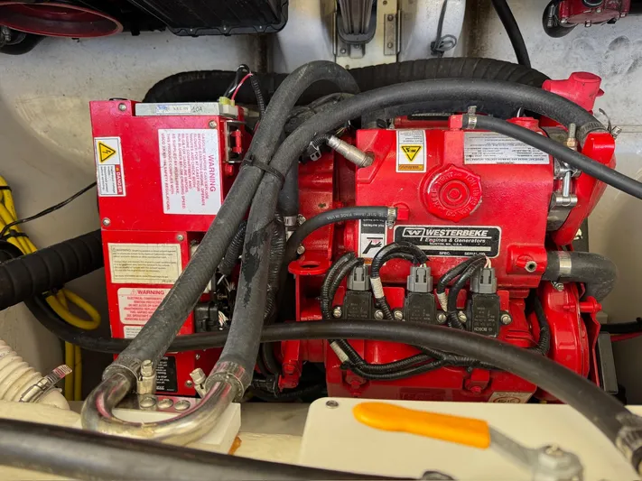The Good Life Yacht Photos Pics Engine compartment of a 2019 Four Winns H350 boat, featuring red mechanical components.