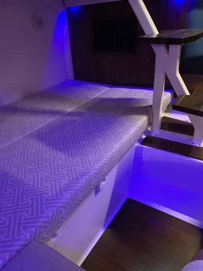 The Good Life Yacht Photos Pics 2019 Four Winns H350 cabin interior with bed and ambient blue lighting.