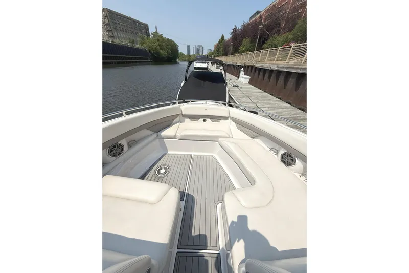 The Good Life Yacht Photos Pics 2019 Four Winns H350 boat with spacious seating, docked by a canal.