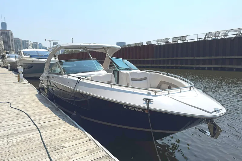 The Good Life Yacht Photos Pics 2019 Four Winns H350 boat docked at a marina, city skyline in background.