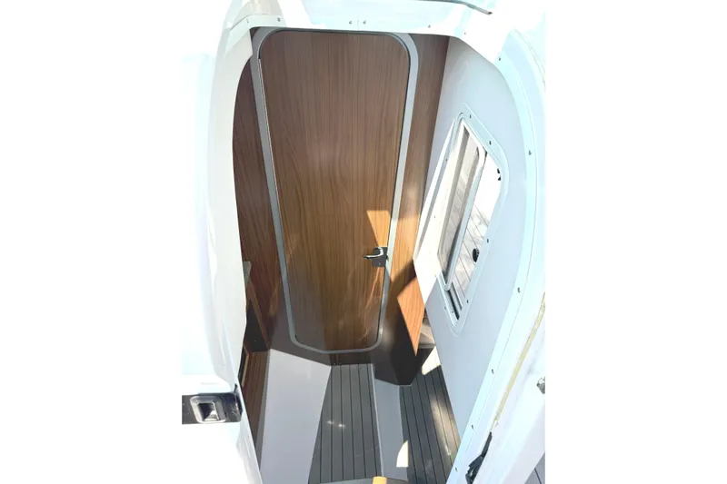 The Good Life Yacht Photos Pics 2019 Four Winns H350 cabin interior with wooden door and window.