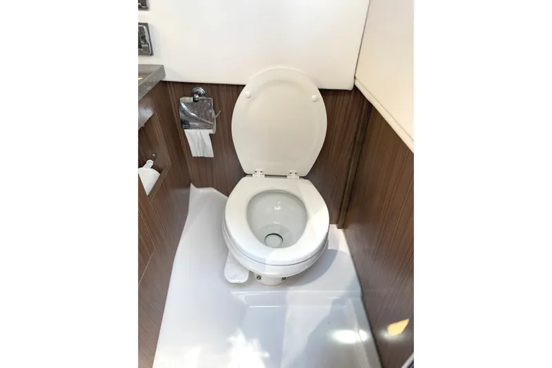 The Good Life Yacht Photos Pics 2019 Four Winns H350 boat bathroom with modern toilet and wood paneling.