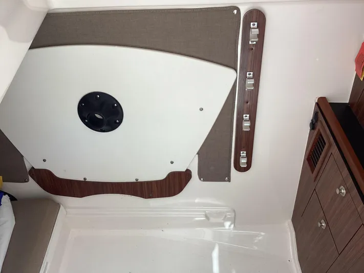  Yacht Photos Pics 2017 Pursuit DC 325 Dual Console interior with wood accents and storage compartments.