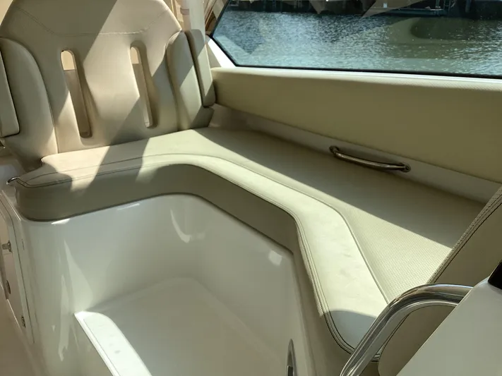  Yacht Photos Pics 2017 Pursuit DC 325 Dual Console interior seating with beige upholstery and water view.