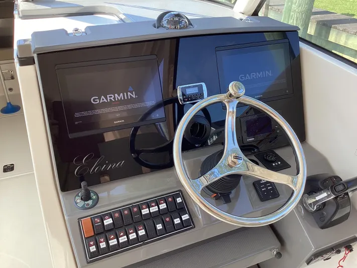  Yacht Photos Pics 2017 Pursuit DC 325 Dual Console helm with Garmin displays and steering wheel.