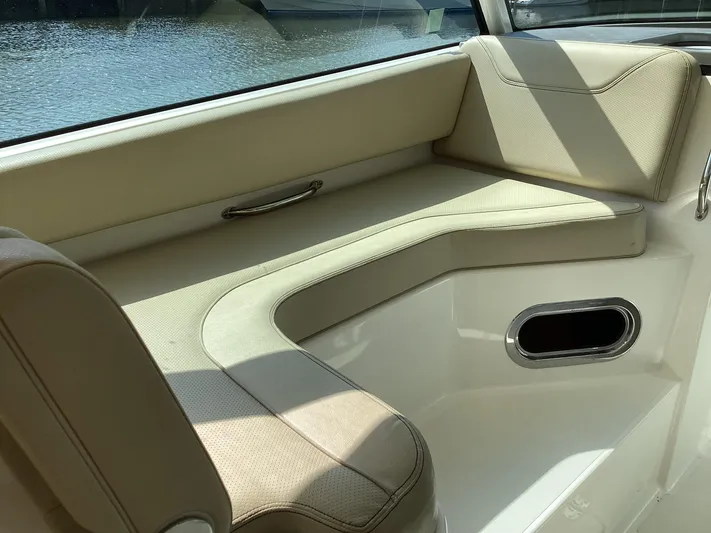  Yacht Photos Pics 2017 Pursuit DC 325 Dual Console interior with beige seating and water view.