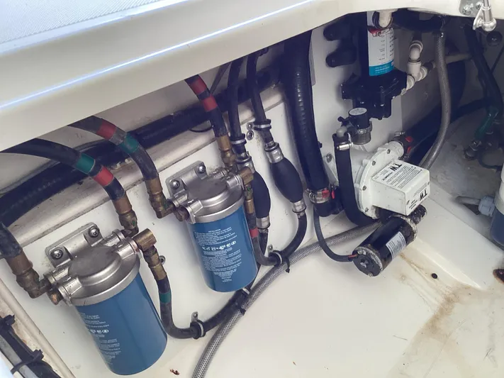  Yacht Photos Pics Engine compartment of a 2017 Pursuit DC 325 Dual Console with visible filters and hoses.