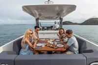 People dining on a Nimbus T11 yacht, enjoying a meal on the open sea.