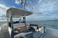 2022 Nimbus T11 boat cruising on open water under a partly cloudy sky.