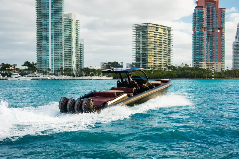 New 2025 Skipper 42 Quad 450r Yacht Photos Pics Skipper-BSK 42NC 2025 boat cruising in urban waterfront, skyscrapers in background.