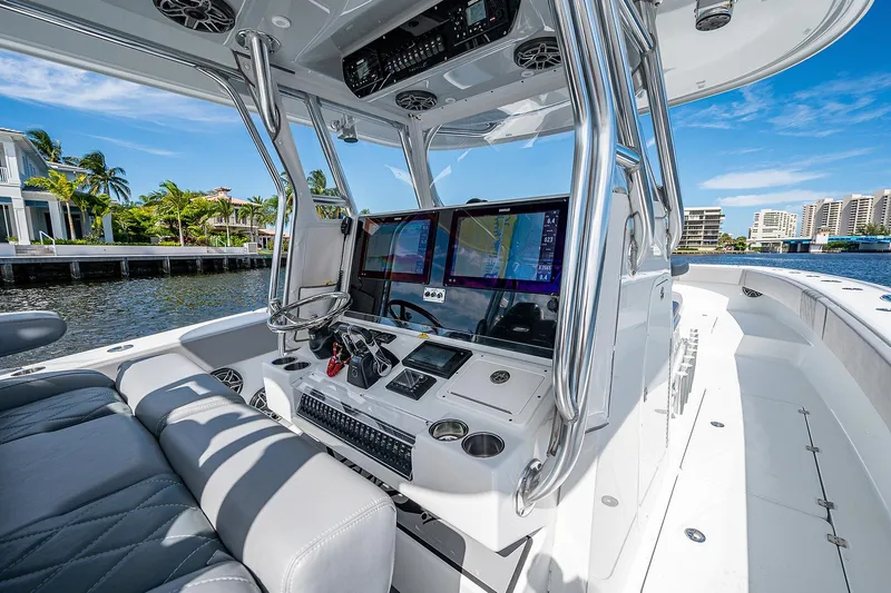 No Woke Zone Yacht Photos Pics Freeman 37 boat cockpit with advanced navigation system, 2019 model, docked by waterfront homes.