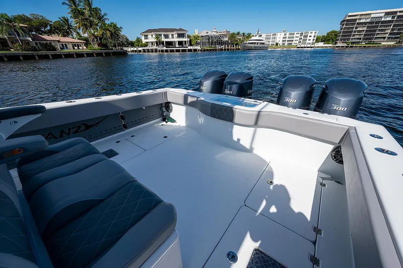 No Woke Zone Yacht Photos Pics Freeman 37 boat, 2019 model, spacious deck with four outboard motors, docked near waterfront homes.