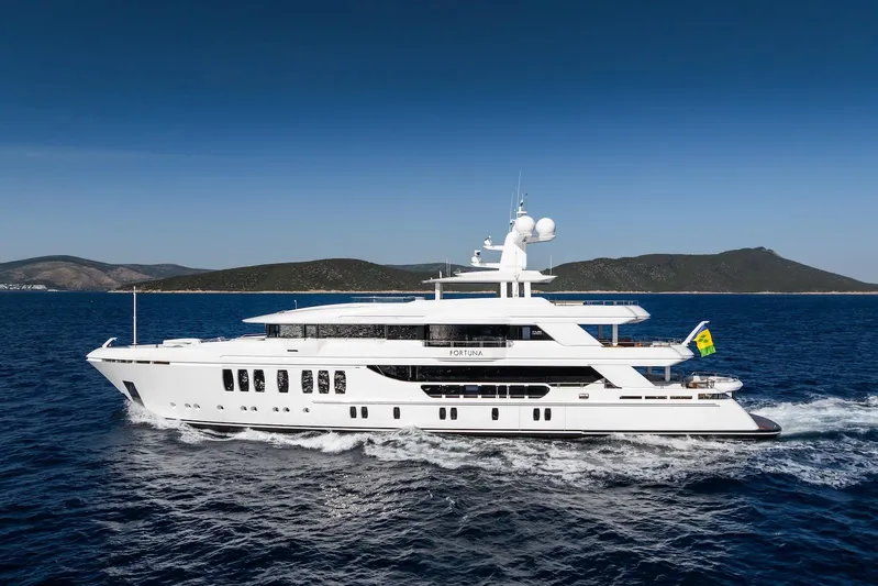 Fortuna Yacht Photos Pics Luxury CMB Yachts CMB 47, 2022 model, cruising on open sea with scenic coastline backdrop.