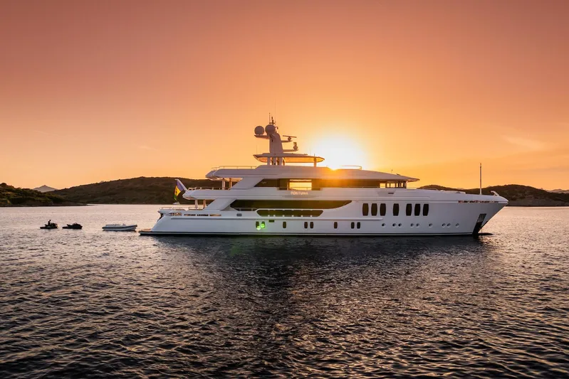 Fortuna Yacht Photos Pics Luxurious 2022 CMB Yachts CMB 47 at sunset on tranquil waters.