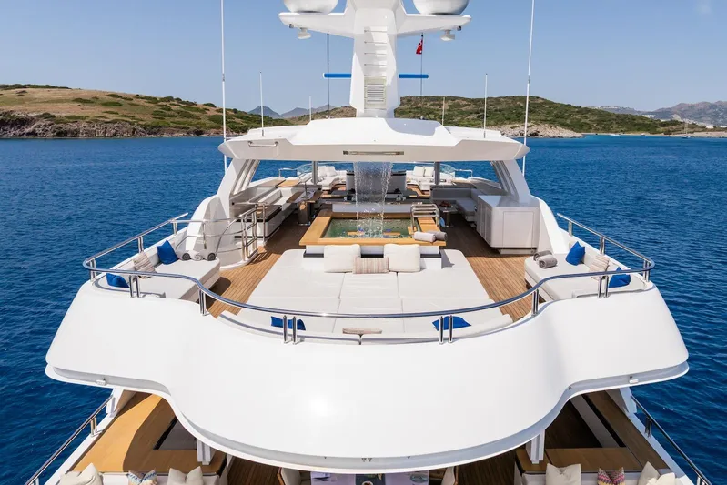 Fortuna Yacht Photos Pics Luxurious 2022 CMB Yachts CMB 47 on serene blue waters, featuring spacious deck and seating.