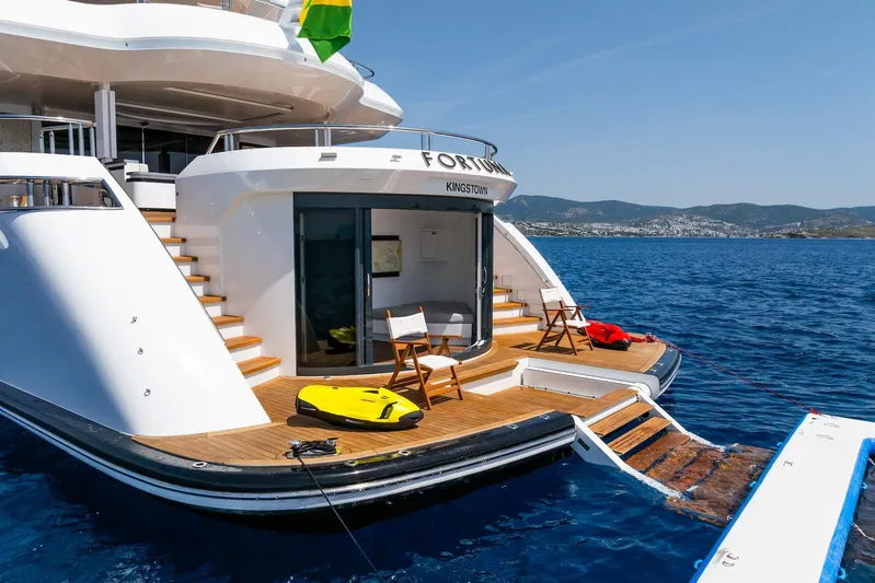 Fortuna Yacht Photos Pics Luxurious 2022 CMB Yachts CMB 47 with elegant deck, docked in serene blue waters.