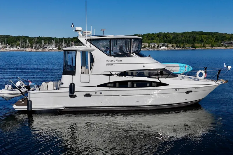 One Last Time II Yacht Photos Pics 2004 Carver 444 Cockpit Motor Yacht on serene water with scenic background.