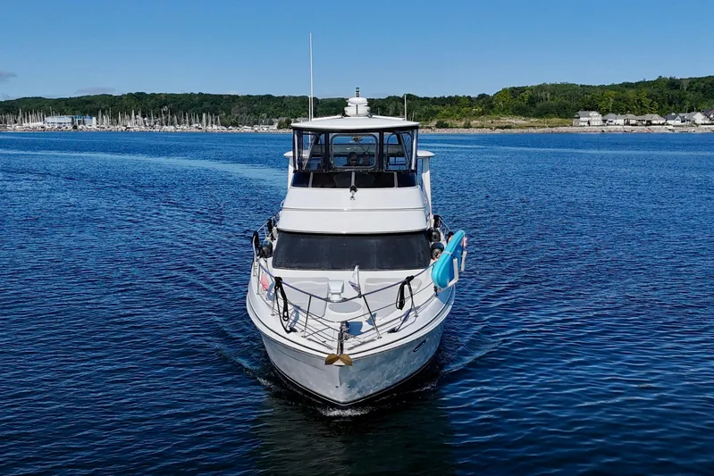 One Last Time II Yacht Photos Pics 2004 Carver 444 Cockpit Motor Yacht cruising on a serene lake.