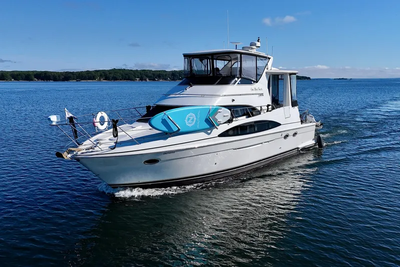 One Last Time II Yacht Photos Pics 2004 Carver 444 Cockpit Motor Yacht cruising on a serene blue lake.