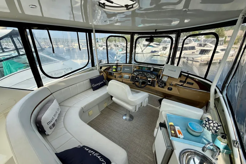 One Last Time II Yacht Photos Pics 2004 Carver 444 Cockpit Motor Yacht interior with helm, seating, and marina view.