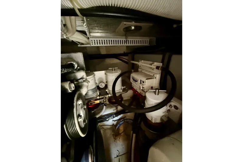 One Last Time II Yacht Photos Pics Engine room of 2004 Carver 444 Cockpit Motor Yacht, showcasing mechanical components and filters.