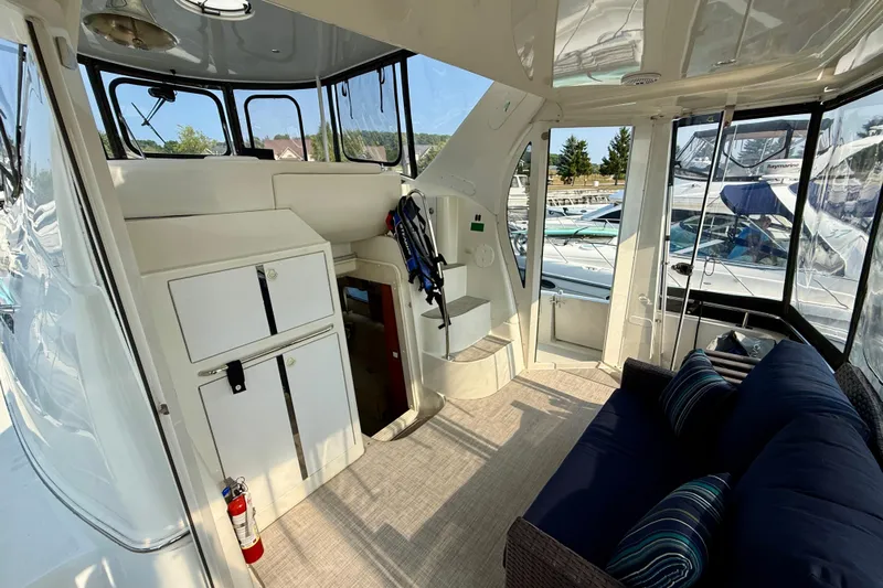 One Last Time II Yacht Photos Pics 2004 Carver 444 Cockpit Motor Yacht interior with seating, storage, and marina view.