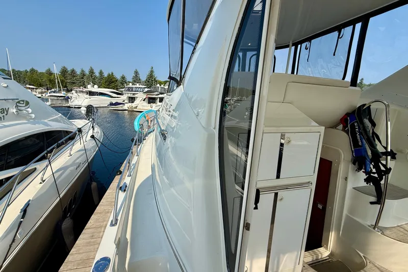 One Last Time II Yacht Photos Pics 2004 Carver 444 Cockpit Motor Yacht docked at marina, side view with open cabin door.