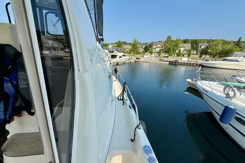 One Last Time II Yacht Photos Pics 2004 Carver 444 Cockpit Motor Yacht docked at a marina, surrounded by water and boats.