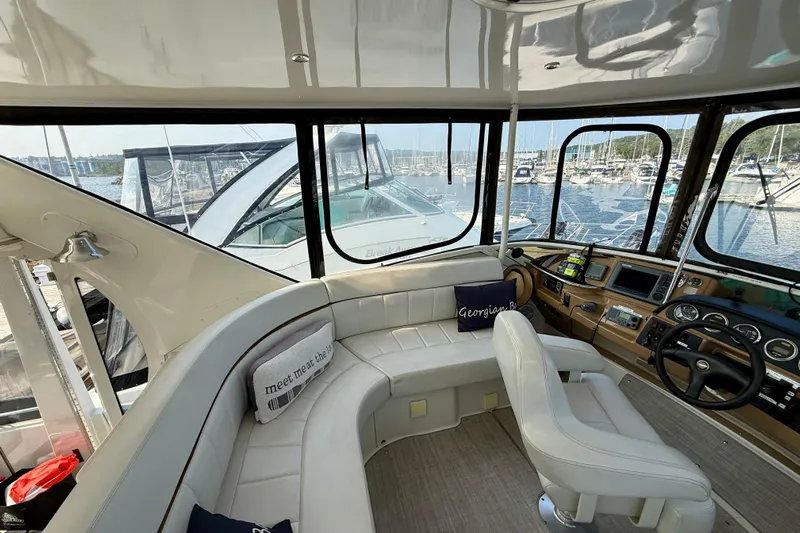 One Last Time II Yacht Photos Pics Interior of 2004 Carver 444 Cockpit Motor Yacht with helm and seating area.