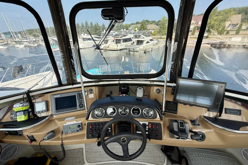 One Last Time II Yacht Photos Pics Cockpit view of 2004 Carver 444 Cockpit Motor Yacht with navigation equipment and marina backdrop.