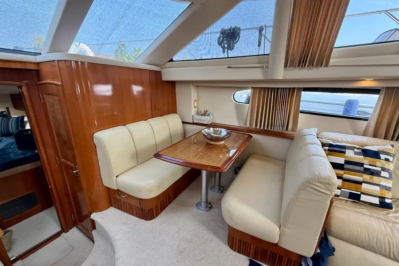 One Last Time II Yacht Photos Pics Luxurious interior of 2004 Carver 444 Cockpit Motor Yacht with elegant seating and dining area.