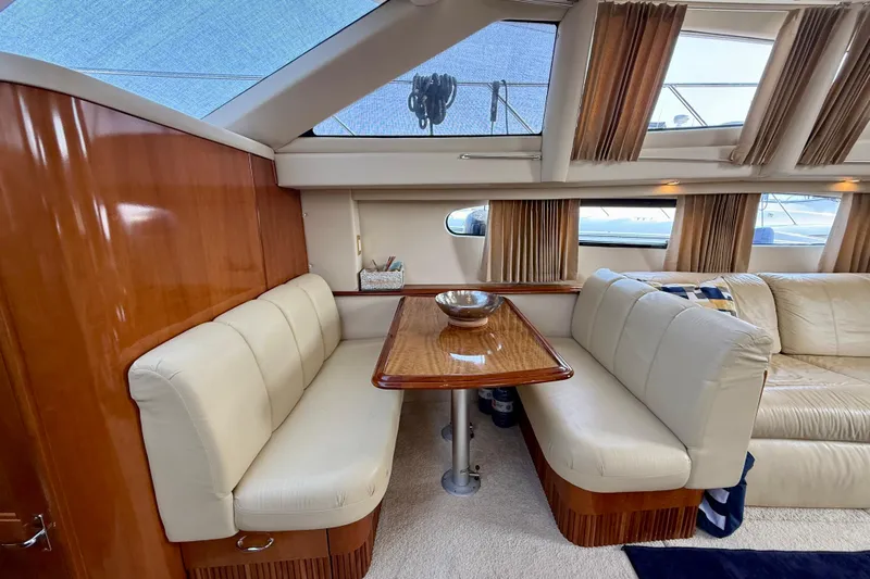 One Last Time II Yacht Photos Pics Luxurious interior of 2004 Carver 444 Cockpit Motor Yacht with plush seating and wooden table.