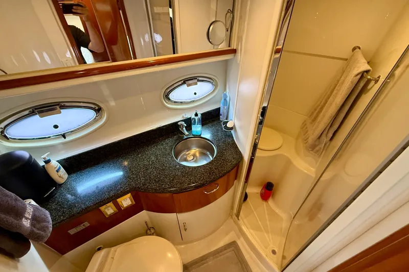 One Last Time II Yacht Photos Pics Luxurious bathroom in 2004 Carver 444 Cockpit Motor Yacht with modern amenities.
