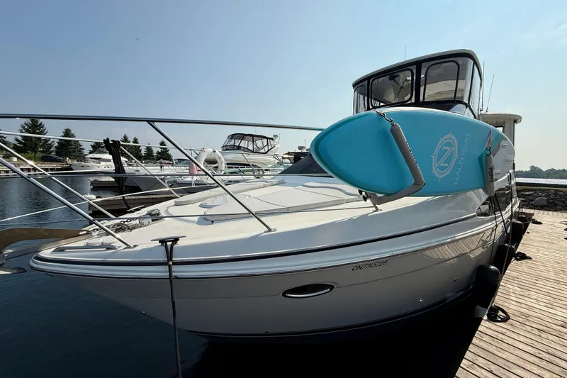 One Last Time II Yacht Photos Pics 2004 Carver 444 Cockpit Motor Yacht docked with a blue paddleboard on deck.