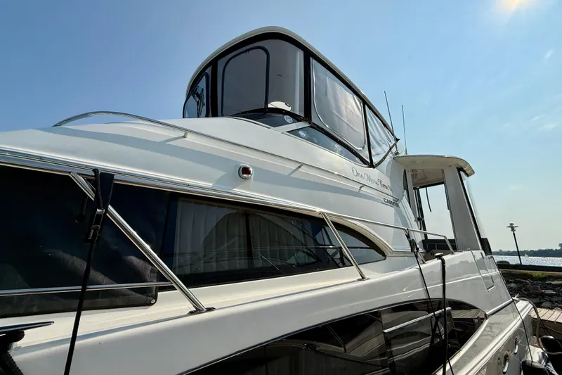 One Last Time II Yacht Photos Pics 2004 Carver 444 Cockpit Motor Yacht docked under clear blue sky.