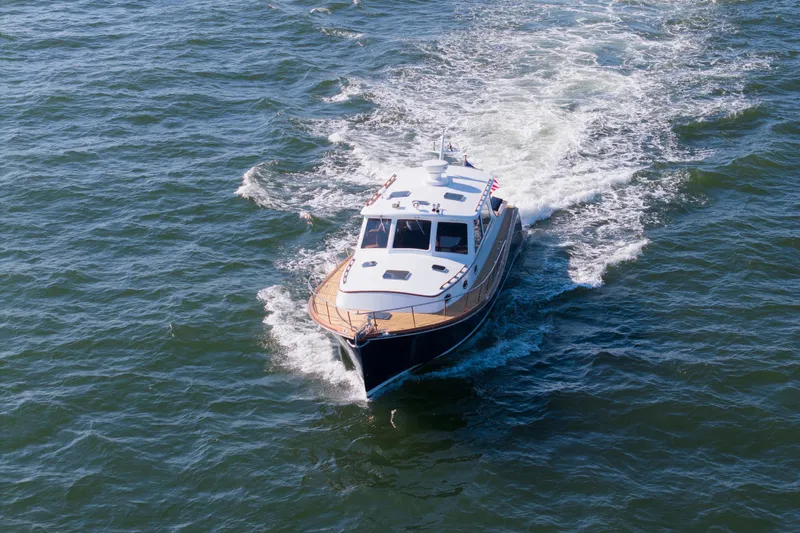 Ingrid Yacht Photos Pics 2007 Gorbon Custom Downeast 40 cruising on open water, creating a wake.