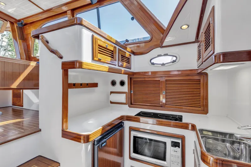 Ingrid Yacht Photos Pics Luxurious 2007 Gorbon Custom Downeast 40 yacht interior with wood accents and modern kitchen amenities.