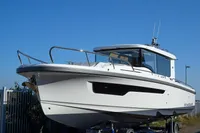 2024 Nimbus Commuter 11 boat with sleek design, docked under clear blue sky.