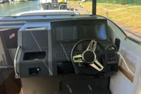 2024 Nimbus Commuter 11 boat dashboard with steering wheel and navigation screens.