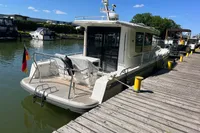 2024 Nimbus Commuter 11 docked at a sunny marina, featuring sleek design and modern amenities.