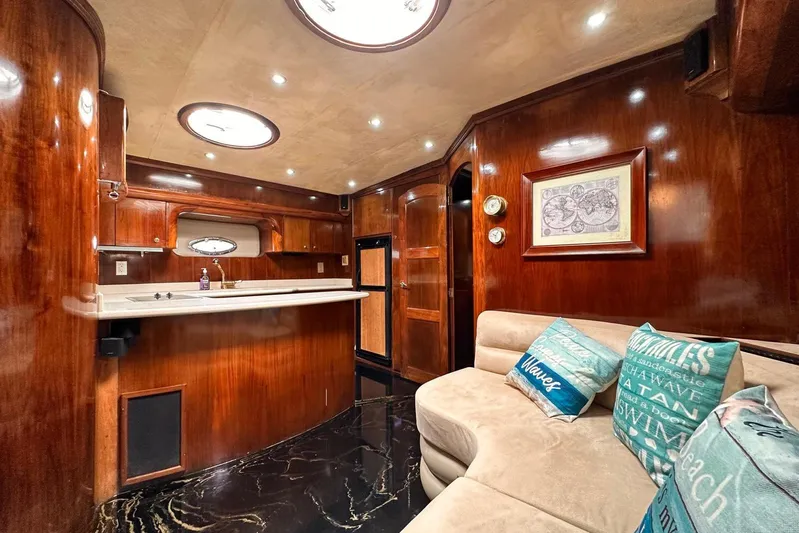  Yacht Photos Pics Luxurious 2002 Navigator Californian Veneti yacht interior with elegant wood finishes and cozy seating.