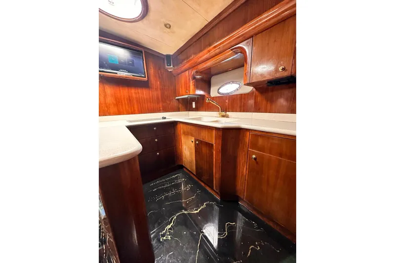  Yacht Photos Pics Luxurious wooden interior of 2002 Navigator Californian Veneti yacht kitchen with modern amenities.