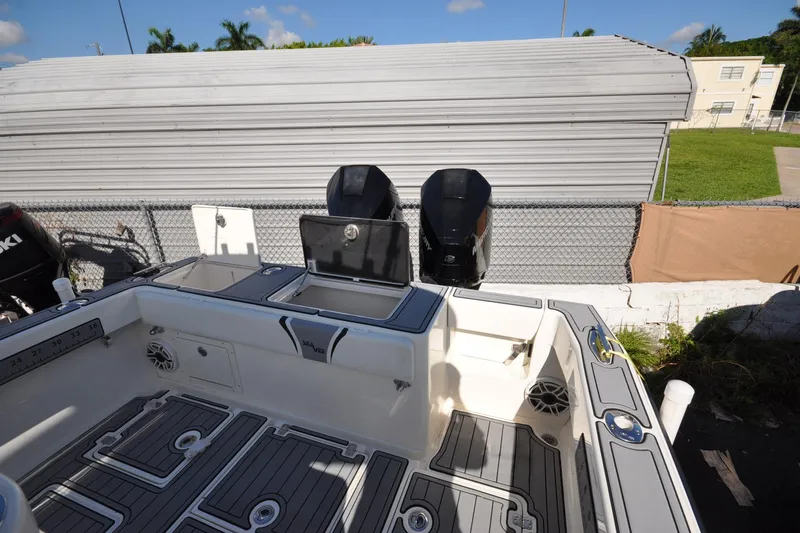  Yacht Photos Pics 2020 SeaVee 290B boat deck with storage compartments and dual outboard motors.