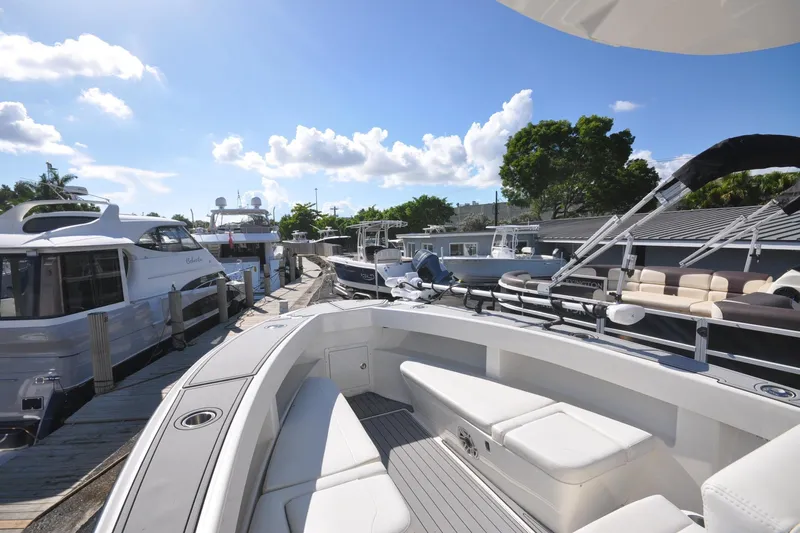  Yacht Photos Pics 2020 SeaVee 290B boat docked at marina under clear blue sky.