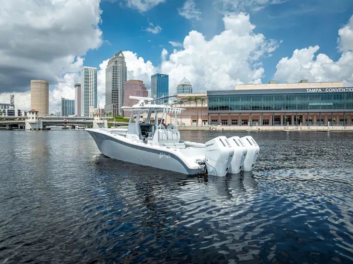  Yacht Photos Pics 2025 Yellowfin 36 boat on water with city skyline background.