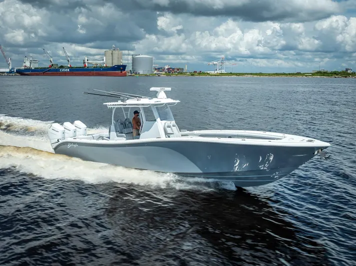  Yacht Photos Pics 2025 Yellowfin 36 boat cruising on water under cloudy sky.