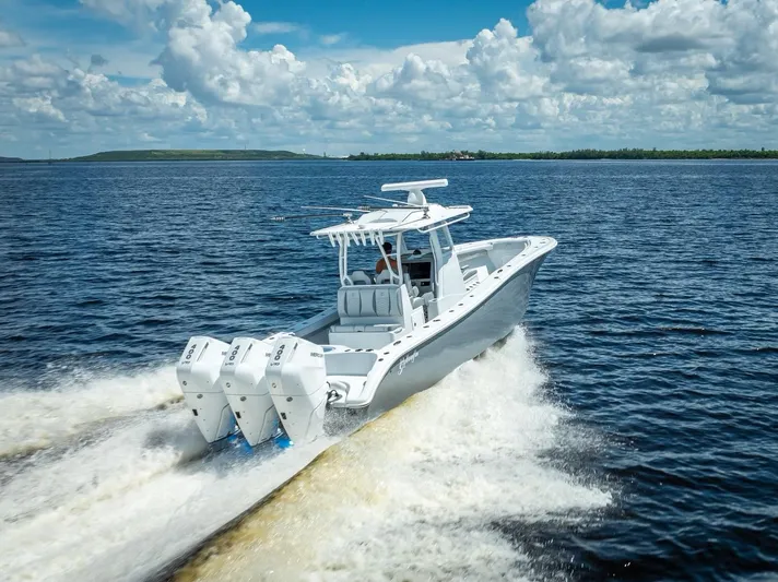  Yacht Photos Pics 2025 Yellowfin 36 boat cruising on open water under a cloudy sky.